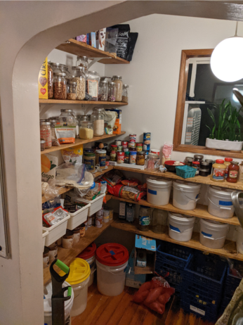 the left side of a full pantry full of shelving